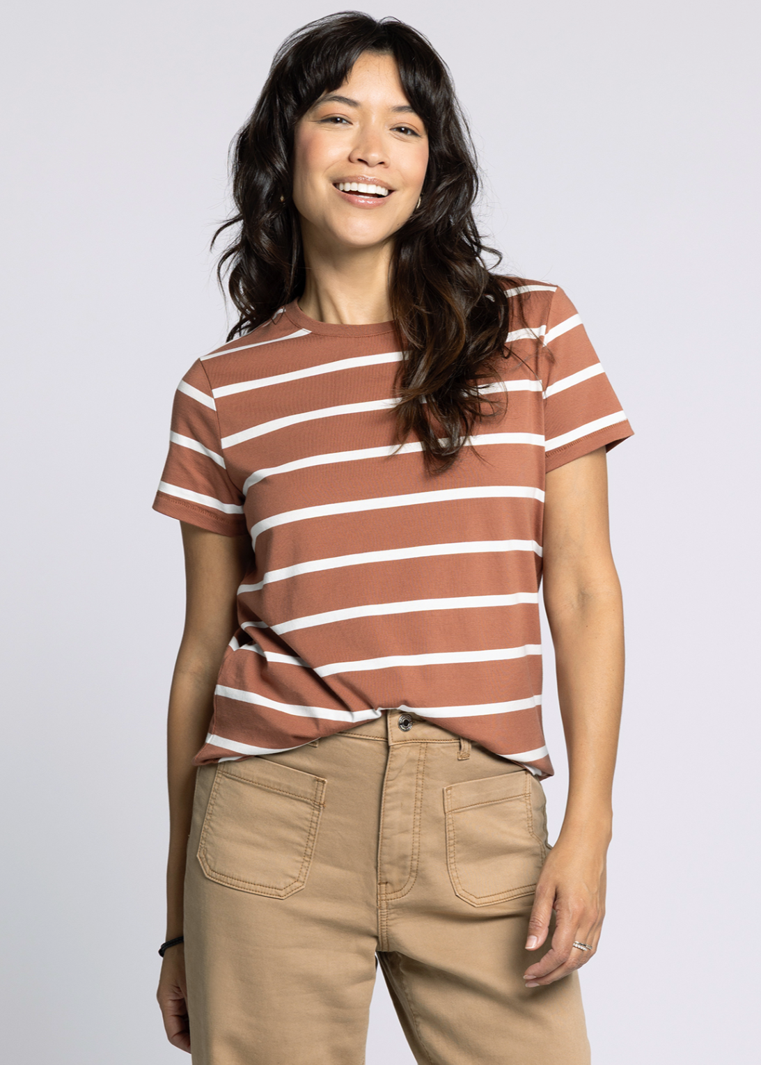 Woman wearing a brown and white striped shirt