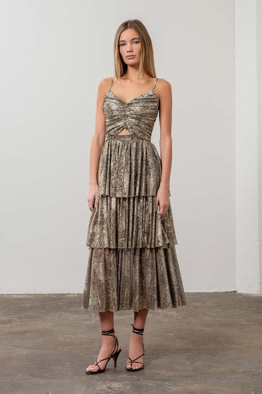 Woman wearing a gold metallic tiered midi dress with ruched bodice and spaghetti straps