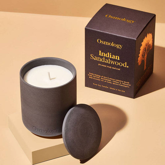 Aery Indian Sandalwood candle and packaging on a beige background